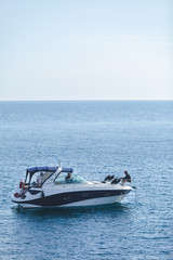 small motor speed boat in sea water with men