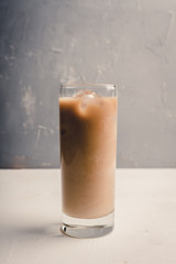 Iced coffee with cream on the rustic background. Selective focus. Shallow depth of field.