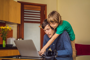 Man is trying to work from home because of the coronovirus epidemic, but his son is stopping him....