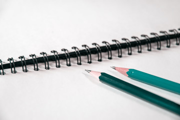 Closeup couple of pencils on a notebook, business or education concept.