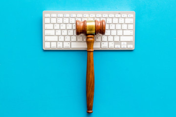 Judge hammer, keyboard on blue lawyer's desk top view copy space