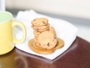 Closeup of chocolate cookies and a cup of coffee.concept for a tasty snack. sweet dessert. rustic wood background. Selective focus. close up.