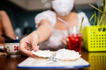 Obraz na płótnie Canvas young women preparing vegetable clear shrimp and pork dumplings in quarantine for coronavirus wearing protective mask during covid-19 pandemic 