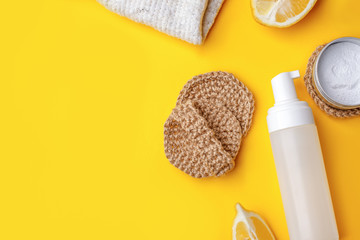 Set of eco-friendly natural cleaning products on yellow kitchen table: soda, essential oils,...