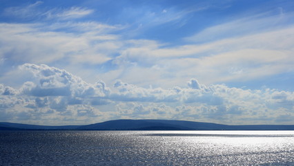 shimmering ocean waters, shispy clouds, blue skyGalway bay, Galway, Ireland, ocean landscape
