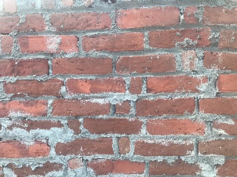 kiln heated clay bricks red used to construct wall partitions for residential building using fleming bond pattern to gain more strength to the villa or real estate construction business