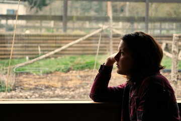 Silhouette of woman gazing out of window