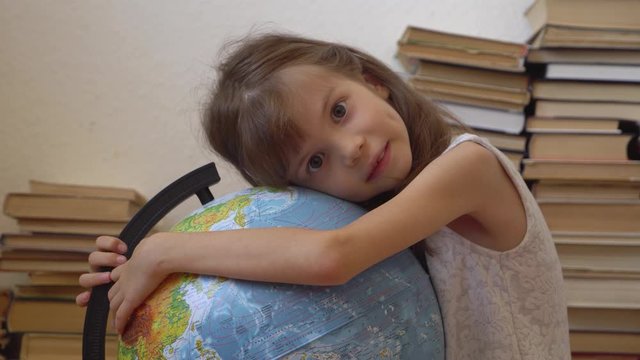 Little girl embracing a globe