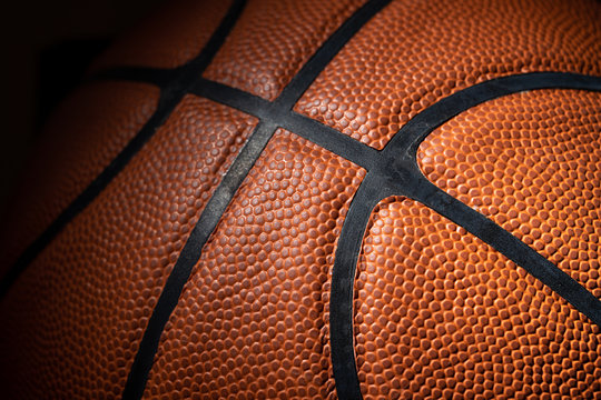 A close-up of a leather basketball on white