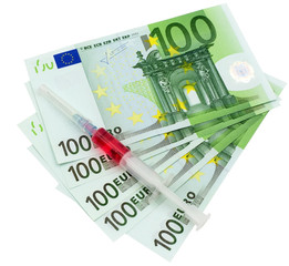 Money and syringe on isolated on white