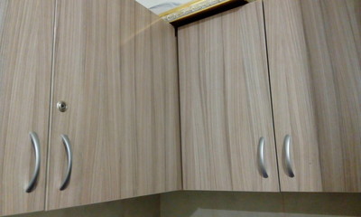 Laminate finished over head storage cabinet with Stainless steel make handle and Lock for an...