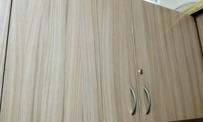 Laminate finished over head storage cabinet with Stainless steel make handle and Lock for an...