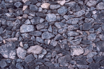 Masonry without cement bond. Cobblestones stacked with space. Main color is Slate Gray. Concept of antiquity.