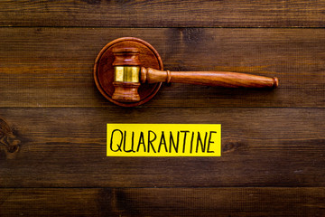 Quarantine penalty. Judge gavel on wooden table top view