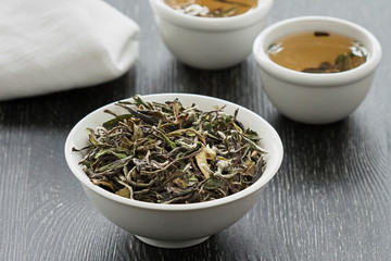 green tea in bowls on a dark background