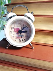 alarm clock and books