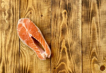 Fresh salmon steak red fish on wooden background 