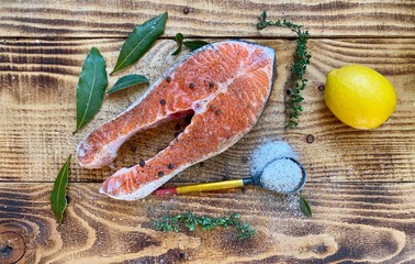 Fillet of pickled red fish on a wooden board. Seafood.