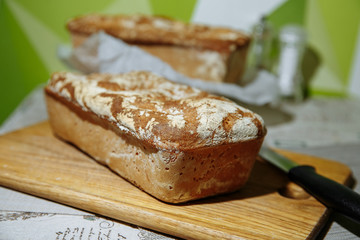 Homemade bread with a knife. Home kitchen. We bake bread at home.