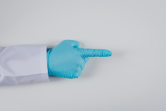 Top View Male Hand In Gloves Pointing Finger On White Background. Horizontal