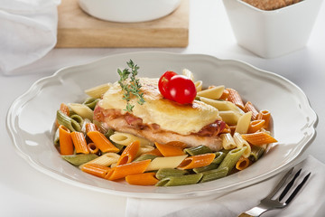 pasta with fish and tomatoes with a sprig of thyme