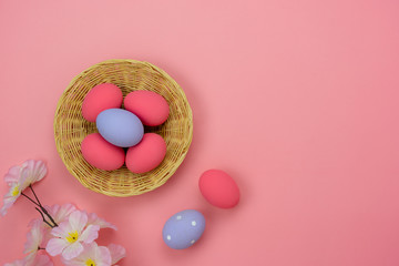 Top view aerial image of decoration & symbol Happy Easter holiday background concept.Flat lay accessory bunny eggs & floral on modern beautiful pink paper at home office desk.Free space for design.