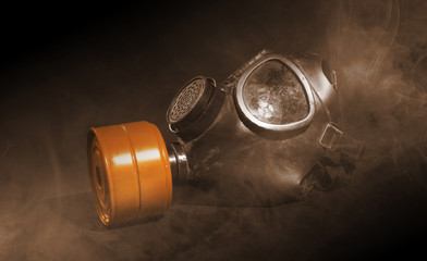 Vintage gasmask isolated on black - Smoke in the room - Orange filter