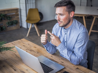 happy smiling remote online working with laptop, mobile phone and notebook in casual outfit sitting...