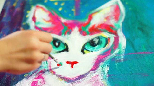Hand with brush adds paint to canvas. Portrait of a cat with a mole. Big eyes. Art therapy combat depression during self-isolation, way to relax. Icreased risk of developing mental health problems 