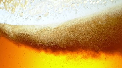 Super Slow Motion Detail Shot of Rippling Beer Bubbles and Foam in Glass at 1000fps. - Powered by Adobe