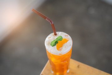 Iced Peach tea on a wooden table in a cafe