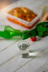 Soju bottle and small glass cup. Alcoholic Clear Distilled Korean Soju.