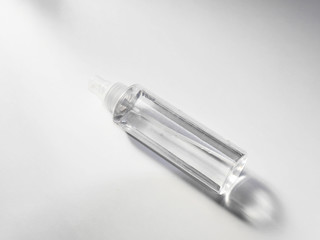 Clear plastic spray bottle on white background