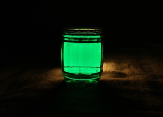 Green water jar placed on the fabric floor.