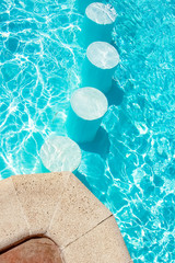 A Step in the pool by the sea nature background. For bathing turquoise water.