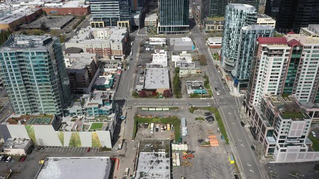 Aerial / drone footage of closed stores and shops, empty streets, without cars, traffic or people in downtown and commercial, business district of Belleview near Seattle, Washington
