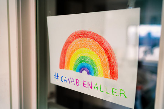 Covid-19 Rainbow window drawing to spread positivity in community for coronavirus stay home self isolation with hashtag #cavabienaller, ca va bien aller social media sharing. Kids drawing.