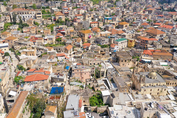 Fototapeta na wymiar Aerial image of the over the old city houses of Nazareth during Corona Virus lockdown, with no people of traffic in the streets. 