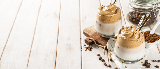 Coffee trend - dalgona coffee, whipped instant coffee on rustic background, copy space