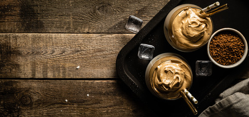 Coffee trend - dalgona coffee, whipped instant coffee on rustic background, copy space