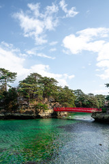 Red bridge connecting two islands in Matshushima Bay near Sendai in Tohoku, Japan on a sunny winter day.