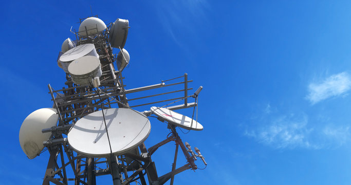 Telco Trellis for 4G 5G Apocalypse Internet Communication, FM Radio and Television Broadcasting On Air with Blue Sky in Background