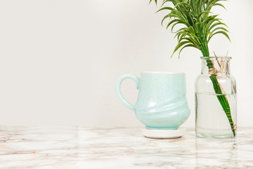 Blue coffee mug with the vase of lavender flowers on a marble table