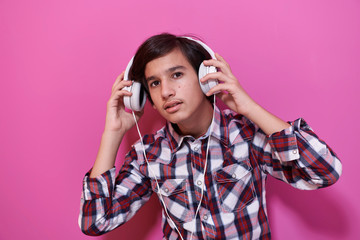 Fototapeta premium Arab Teenage Boy Wearing Headphones And Listening To Music