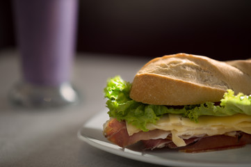 closeup of ham and cheese sandwich with raspberry juice. food photography