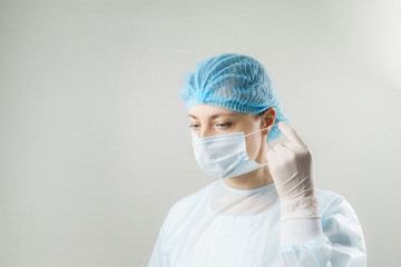 Doctor with protective clothing and face mask in clinic at Covid-19 coronavirus epidemic