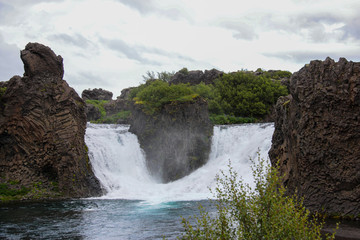 the confluence of two small waterfalls in one river, on the edges of the waterfalls are beautiful...