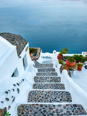 A morning shot of the Greek island of Santorini showing steps leading down to apartments. 