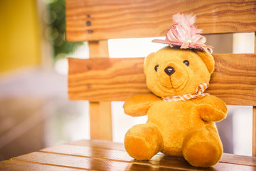 teddy bear with scarf and hat on wooden background