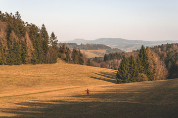 young woman runs in autumn landscape in the countryside